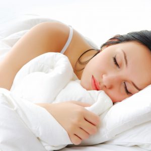 An image of a woman sleeping to promote the medicated sleep ease patch with melatonin from Frequency Apps